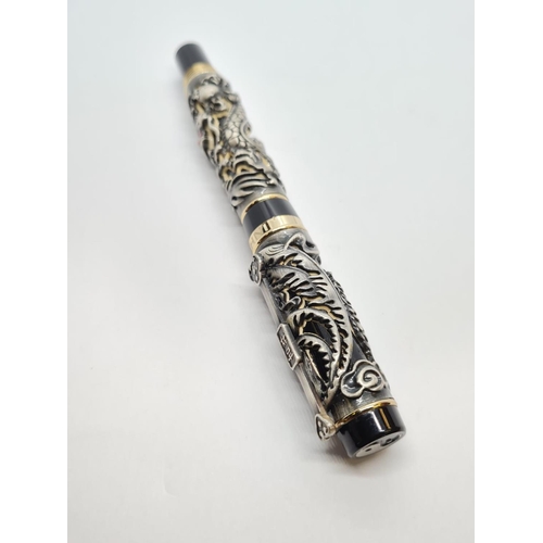 244 - Jinhao dragon pen in black. Having a dragon and birds in relief work to outer case. 18ct gold plated... 