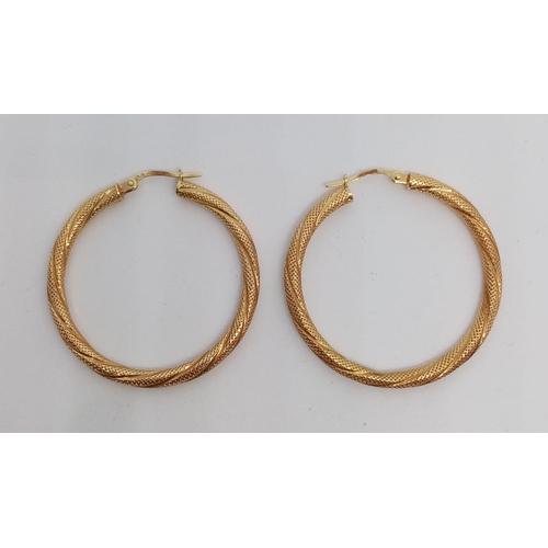 282 - A pair of 9ct gold hoop earrings. 2.3g in weight.