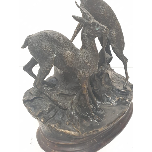 306 - A vintage bronze sculpture of two deer, alert to the danger around them. 25 x 30 cm.