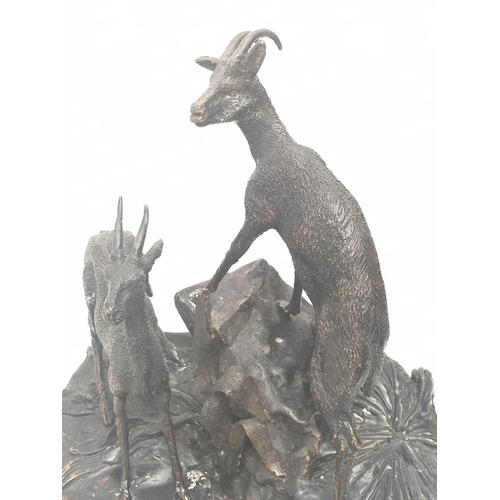 306 - A vintage bronze sculpture of two deer, alert to the danger around them. 25 x 30 cm.