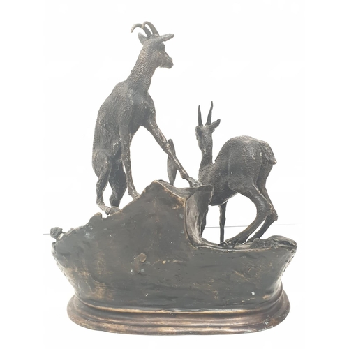 306 - A vintage bronze sculpture of two deer, alert to the danger around them. 25 x 30 cm.