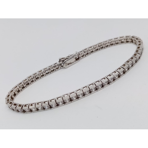 307 - Silver tennis bracelet having 54 channel set clear stones. 7 1/2 inches / 19cm approx. Fully hallmar... 