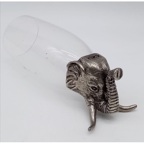 355 - A hunter's drinking cup with white metal base, in the style of an elephant. 17cm in height.