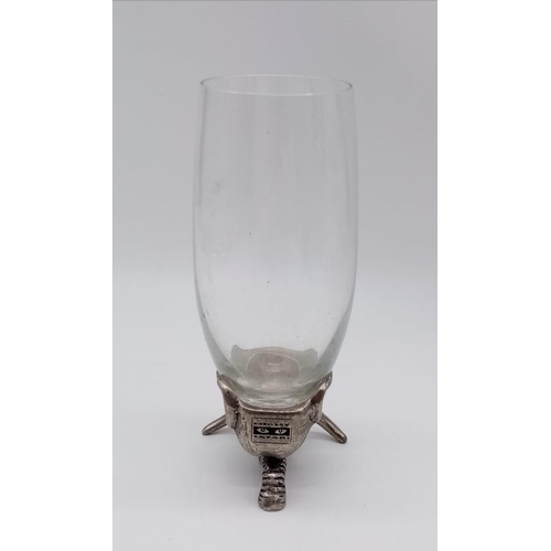 355 - A hunter's drinking cup with white metal base, in the style of an elephant. 17cm in height.