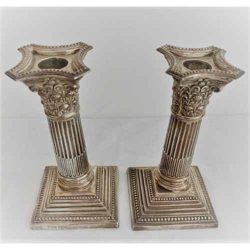 2 - Pair of antique silver candlesticks having Corinthian pillars on a beaded base with ornate scrollwor... 