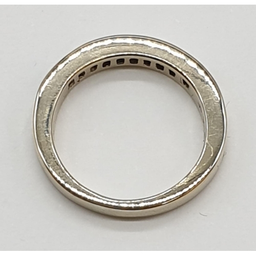 28 - 18ct White gold half eternity ring with inset sapphire and diamonds, 4.9g and size K.