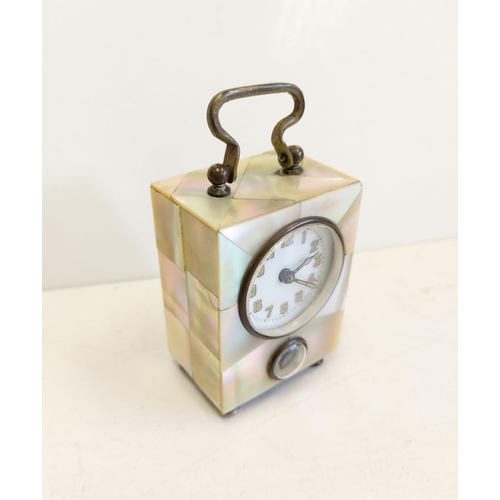 137 - German mother of pearl cased alarm clock, with twin face. 5x6cm.