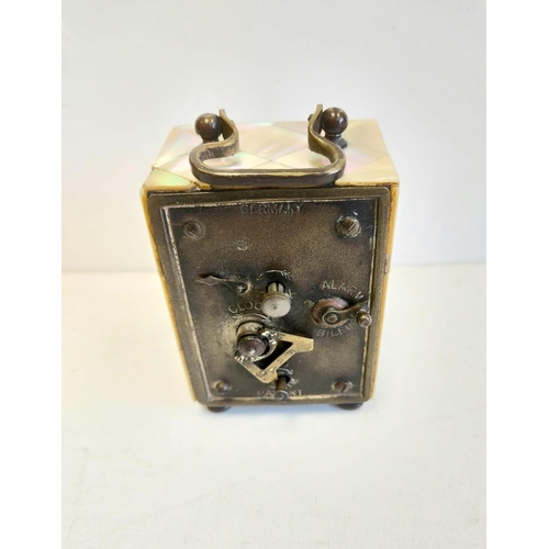 137 - German mother of pearl cased alarm clock, with twin face. 5x6cm.