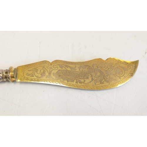 143 - A silver gilt-in scripted large fish knife; with decorated handle. 27cm long.