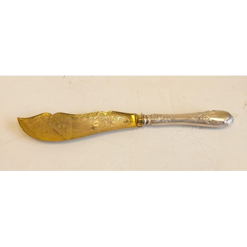 143 - A silver gilt-in scripted large fish knife; with decorated handle. 27cm long.