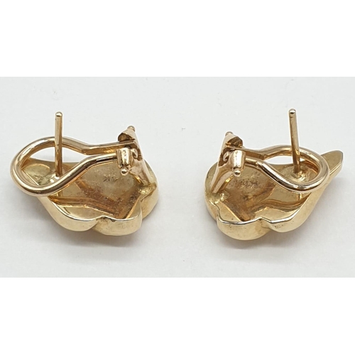 149 - A pair of 14ct gold earrings with turquoise inlays. 8.4g.