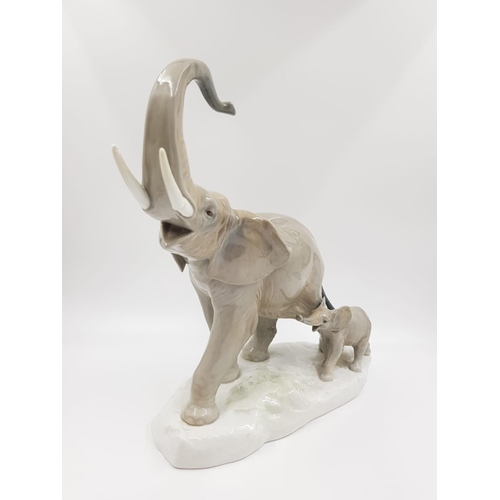 170 - A Lladro porcelain figuriene of a mother and baby calf elephant. Slight damaged to one of the tusks.... 