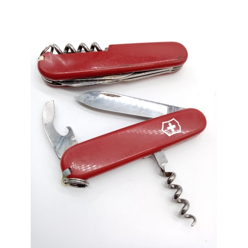 353 - A pair of Swiss army knives.