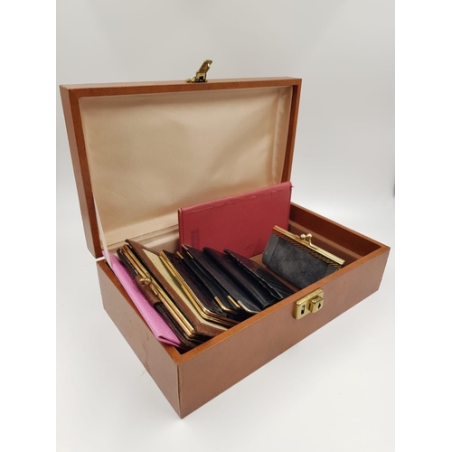 604 - A selection of 9 women's leather and snakeskin purses and wallets in a lovely presentation box.