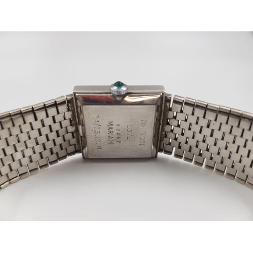 625 - A Milner ladies watch, stainless steel strap and emerald face. Comes with case.