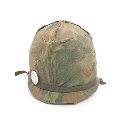 76 - Vietnam War Era US M1 Helmet with Reversible Mitch-Duck Hunter Cover. The peace pin may be post war.