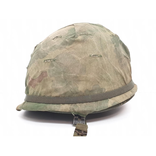 76 - Vietnam War Era US M1 Helmet with Reversible Mitch-Duck Hunter Cover. The peace pin may be post war.