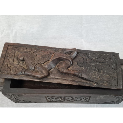 599 - Carved tribal box with sliding lid, 42x8cm