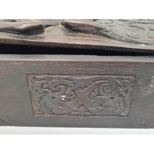 599 - Carved tribal box with sliding lid, 42x8cm