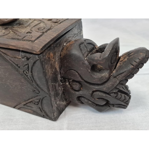 599 - Carved tribal box with sliding lid, 42x8cm