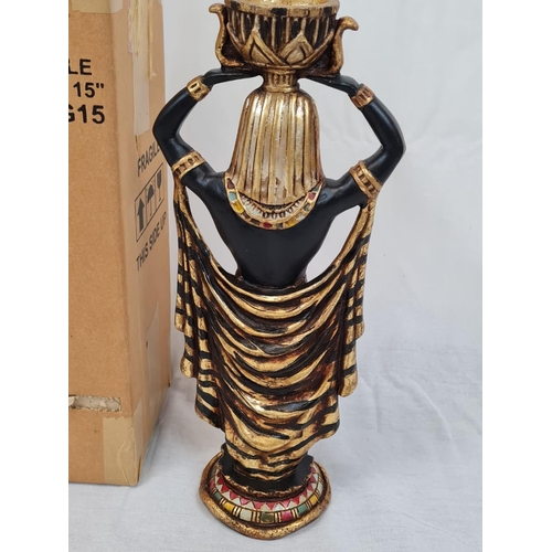 691 - A pair of Egyptian candle holders, with gilded decoration. 40cm high.