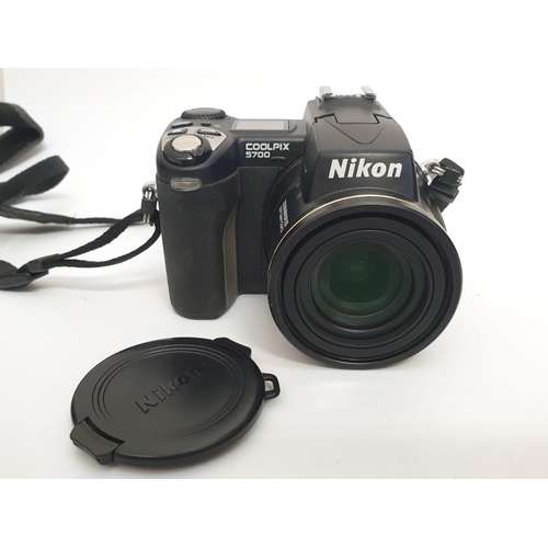 763 - A Nikon Coolpix 5700 digital camera. Includes charger, lens cap and case. As found.