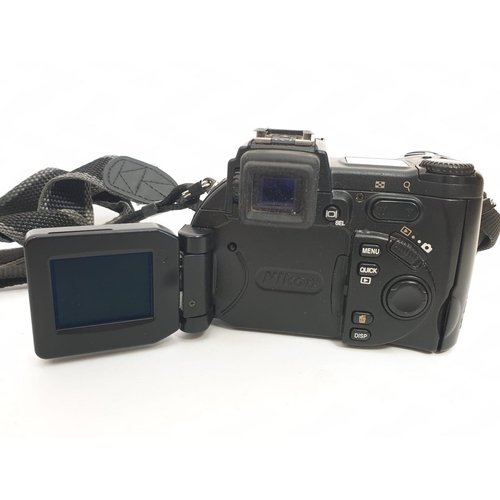 763 - A Nikon Coolpix 5700 digital camera. Includes charger, lens cap and case. As found.