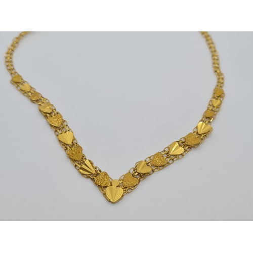 79 - 22ct yellow gold heart decorated necklace, weight 6.8g and 42cm long approx