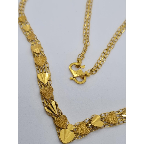 79 - 22ct yellow gold heart decorated necklace, weight 6.8g and 42cm long approx