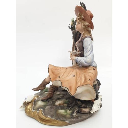 976 - A Capodimonte figure of a pretty girl playing with birds.