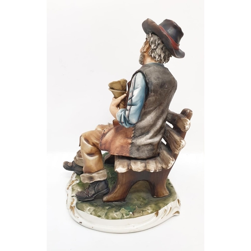 979 - A Capodmonte figure of an old man feeding birds. 30cm high x 24cm diameter.