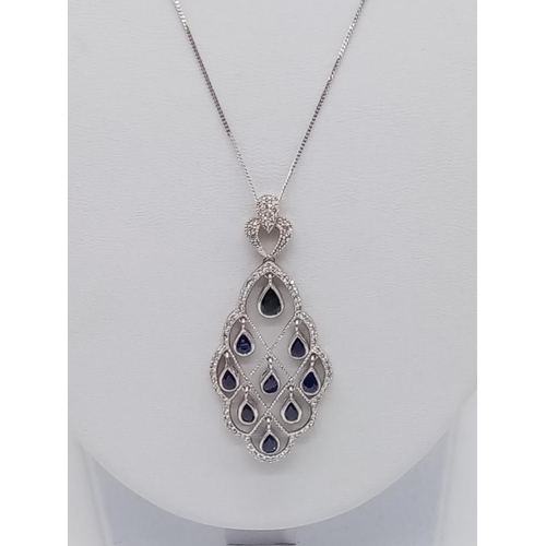 935 - 18CT DIAMOND AND SAPPHIRE PENDANT ON A 42CM CHAIN, WEIGHT 7.4G