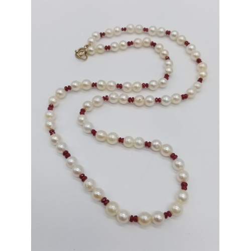 961 - Cultured pearl and ruby necklace. 46cm in length. 16.6 grams in weight.