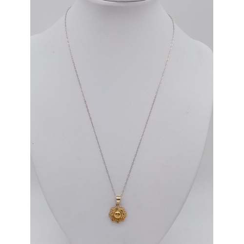 966 - Antique 9ct gold pendant on chain. 44cm in length. 1.2g in weight.