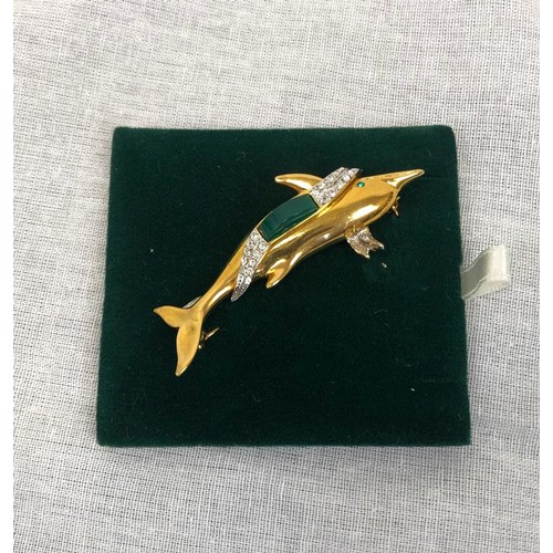 903 - A 22ct gold plated dolphin brooch with diamondesque decoration. As new; in box. 60cm long.