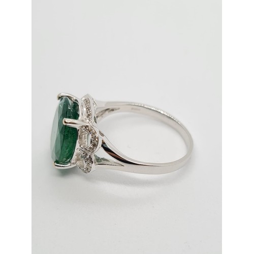 34 - 18ct white gold with 4ct emerald and diamond ring, weight 4.2g and size N