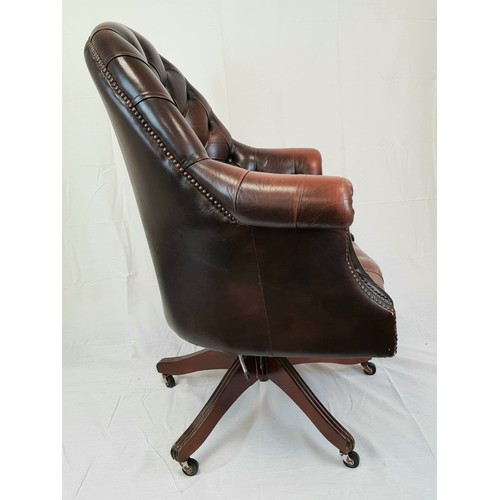 41 - A vintage Chesterfield directors swivel office chair. Brown leather, deep buttoned and flanked by sc... 