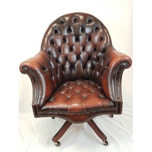 41 - A vintage Chesterfield directors swivel office chair. Brown leather, deep buttoned and flanked by sc... 