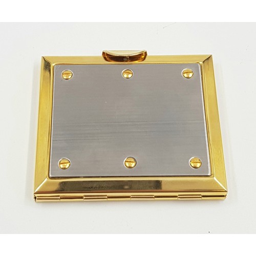 887 - A gold and silver effect metal vanity mirror case. As new with box. 7x6cm.