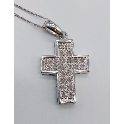 951 - 9ct white gold diamond cross pendant on 38cm chain, weight 2.6g