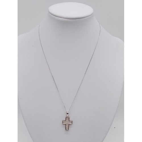 951 - 9ct white gold diamond cross pendant on 38cm chain, weight 2.6g