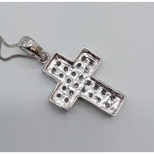 951 - 9ct white gold diamond cross pendant on 38cm chain, weight 2.6g