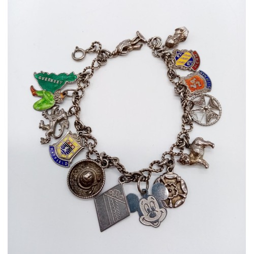 1000 - Silver charm bracelet with 13 charms, weight 28.4g