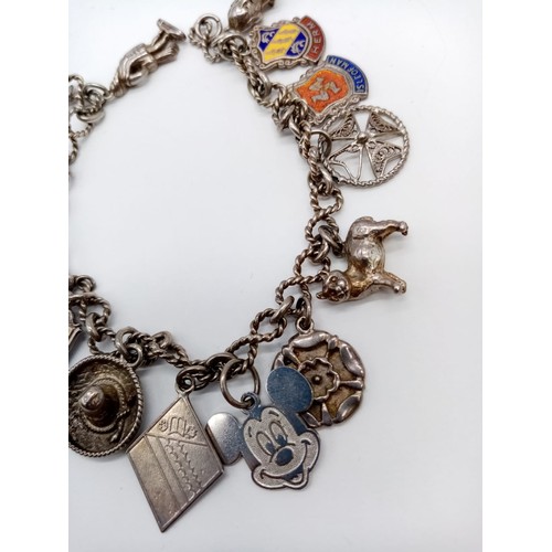 1000 - Silver charm bracelet with 13 charms, weight 28.4g