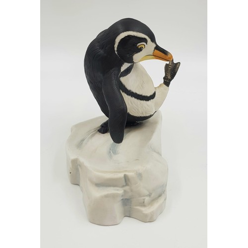 894 - A hand painted porcelain figurine of a penguin slipping on ice. 'Whoops!' Good condition. 15x15cm.