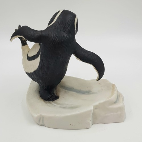 894 - A hand painted porcelain figurine of a penguin slipping on ice. 'Whoops!' Good condition. 15x15cm.