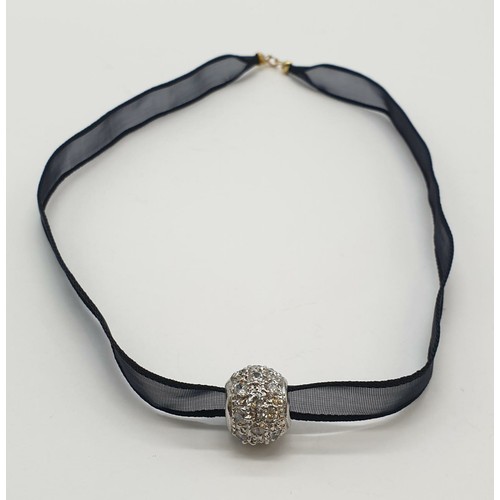 995 - Black fabric chocker with 18ct gold clasp and a 9ct decorative charm. 5.3g in weight.