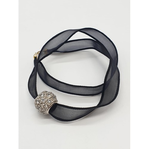 995 - Black fabric chocker with 18ct gold clasp and a 9ct decorative charm. 5.3g in weight.