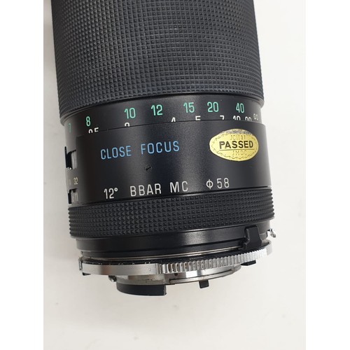 764 - A Tamron close focus 200mm lens. Good condition, 17cm long with case.