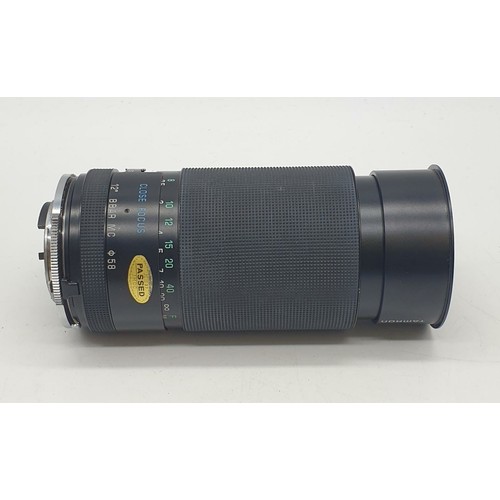 764 - A Tamron close focus 200mm lens. Good condition, 17cm long with case.